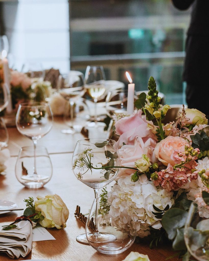 Styled table detail with florals, candles and glassware
