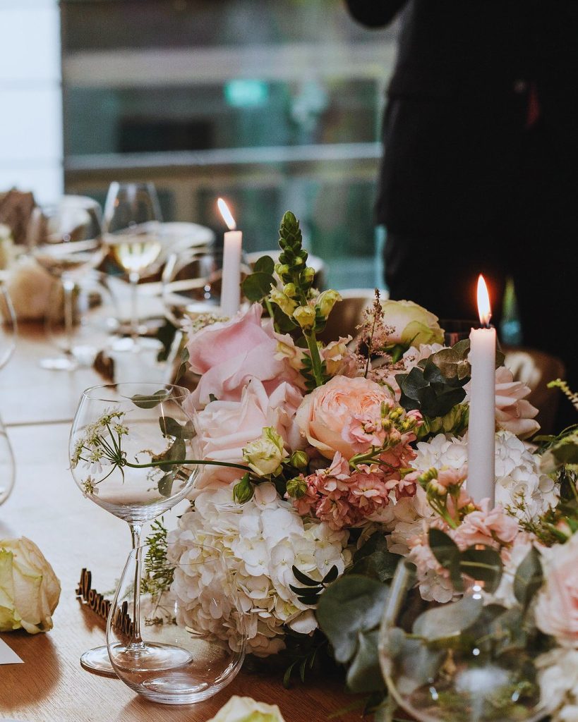 Candlelit long table with blush florals, linen napkins and tapered candles