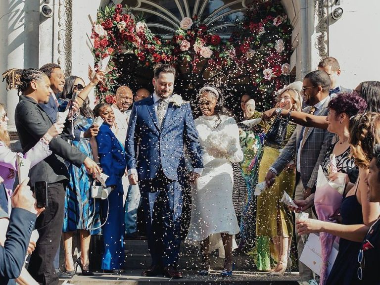 Bride and groom leaving a London townhouse wedding under a shower of confetti